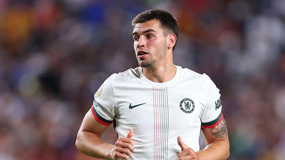 Marc Guiu looks on in a Chelsea shirt