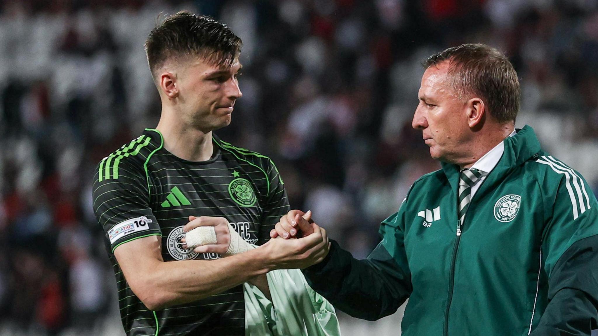 Celtic manager Brendan Rodgers (R) and Kieran Tierney at full time during a UEFA Europa League match between FK Crvena Zvezda and Celtic at the Stadion Rajko Mitic
