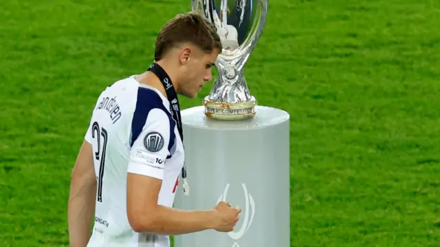 Micky van de Ven walks past the European Super Cup after Tottenham are beaten by Paris St-Germain