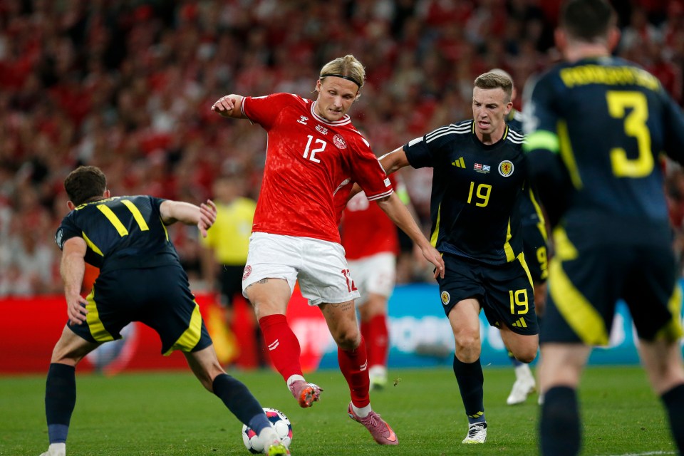 Kasper Dolberg of Denmark competing for the ball during a soccer match.